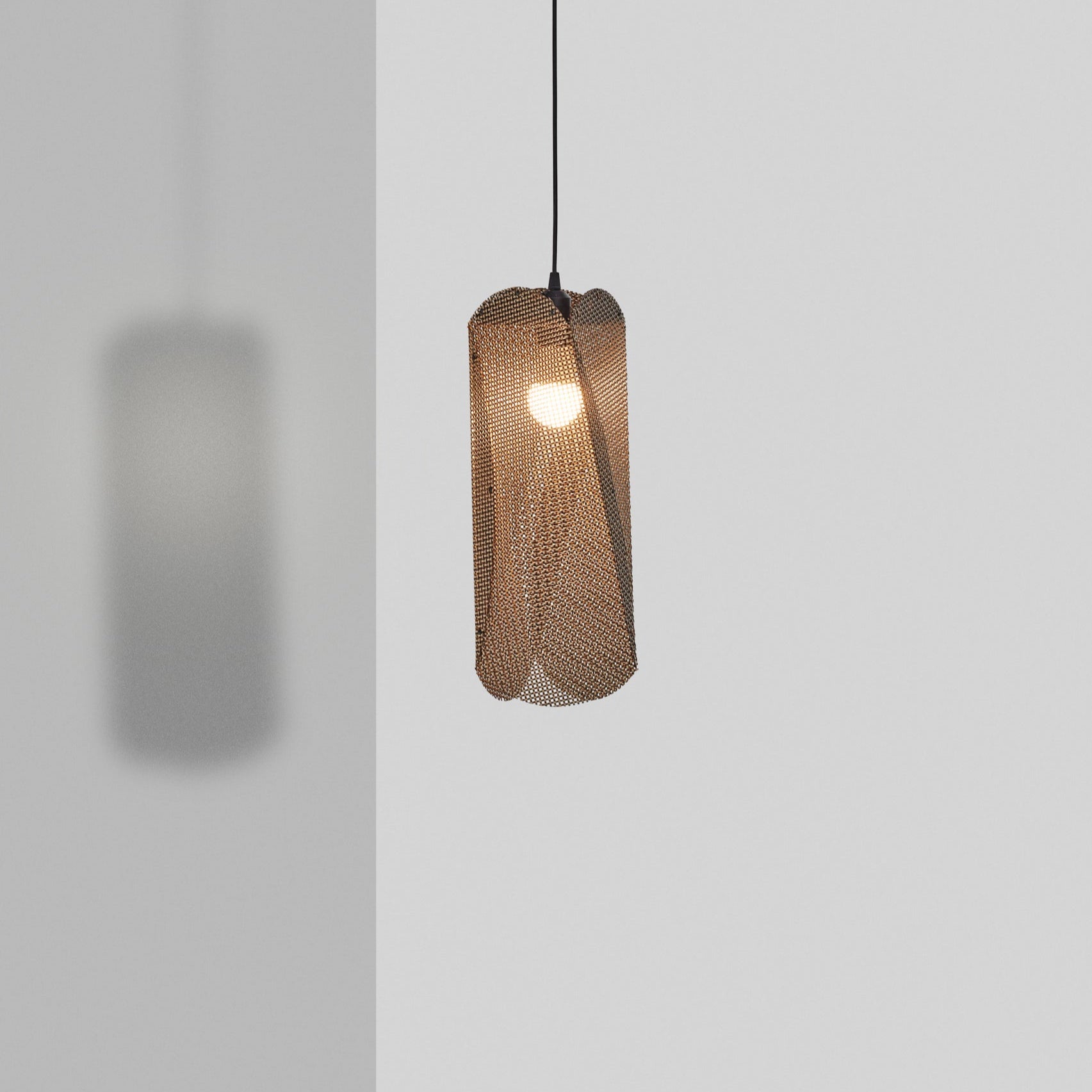 Toki Pendant light with woven design on a plain background